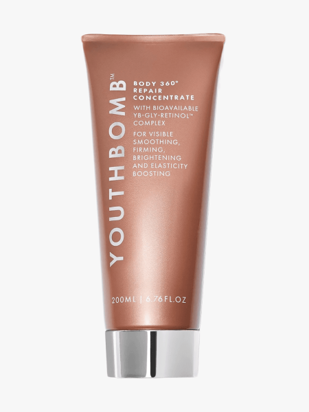 Beauty Pie Youthbomb Body 360° Repair Concentrate in branded metallic copper colored tube on light gray background
