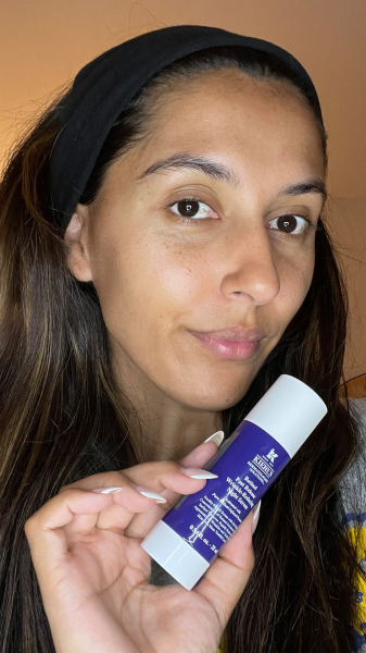 A selfie of Allure associate special projects manager Talia Gutierrez holding Kiehl's Retinol Skin Renewing Daily...